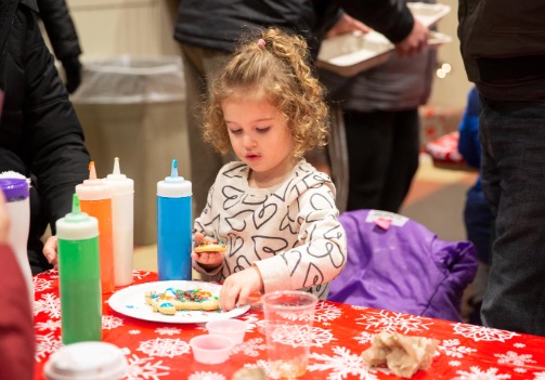 child decorating cookies at ZooLights
